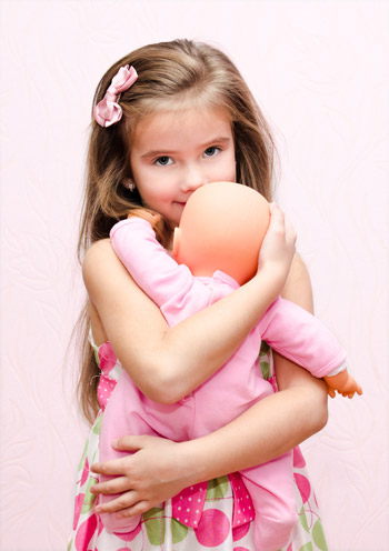 girl hugging her doll