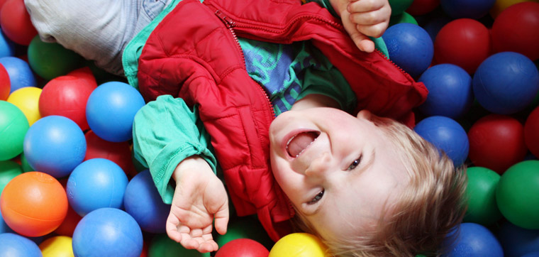 boy playing with plastic balls