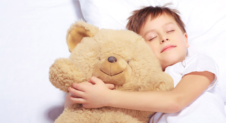 boy sleeping with teddy bear