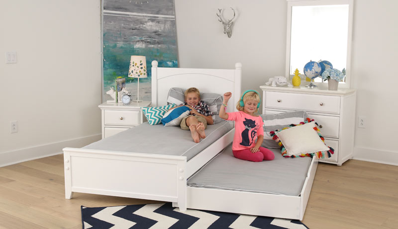 happy brother and sister on Maxtrix trundle bed with a white finish