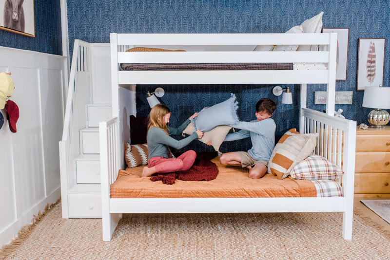 brother nad sister having a pillow fight on a Maxtrix bunk bed