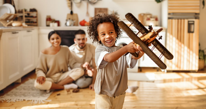 child with toy wooden airplane