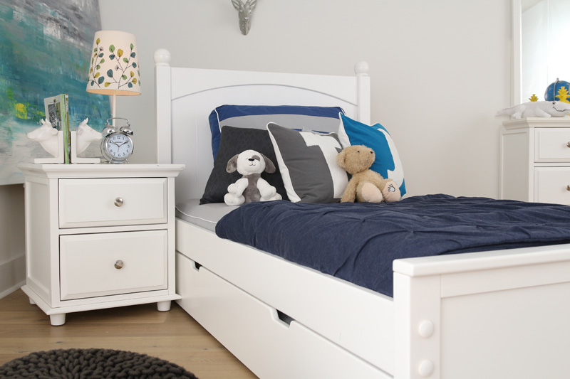 childs bedroom with stuffed animals on bed