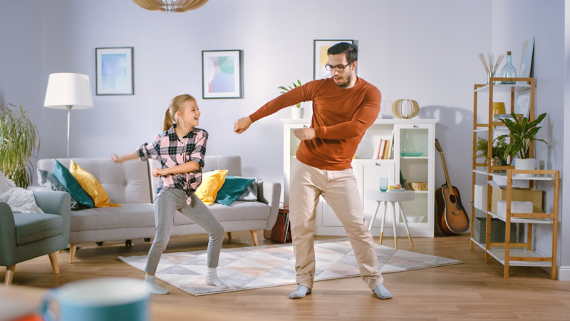 dad and elementary age daughter dancing