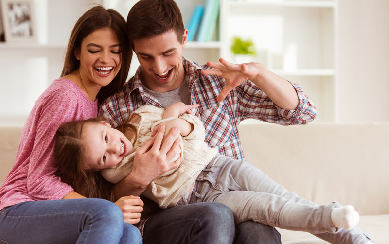 dady with mom and tickling young child