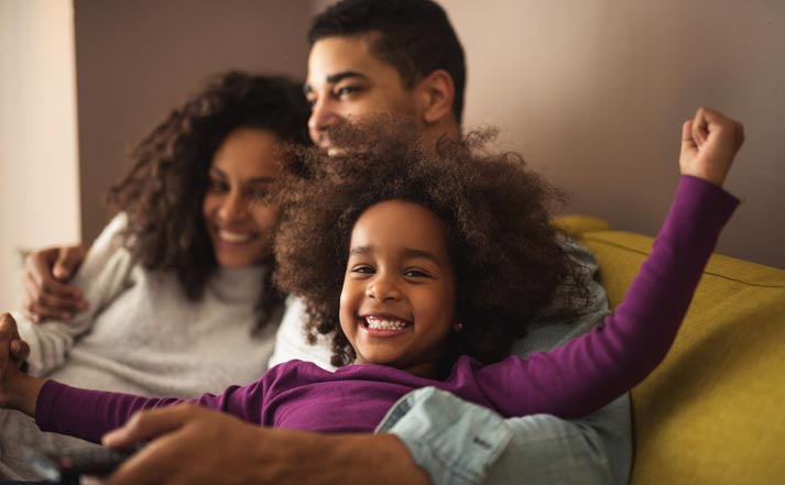 excited and happy young girl with her parents