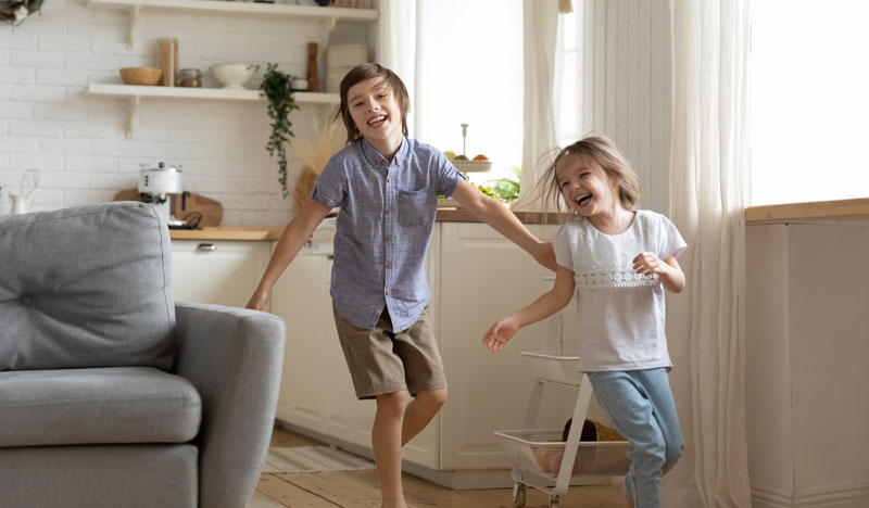 excited kids running noisily around the house