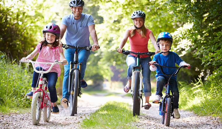 family enjoying a bike ride on a country trail