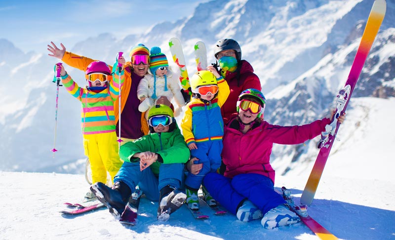 family on snow covered mountain posing for pictures