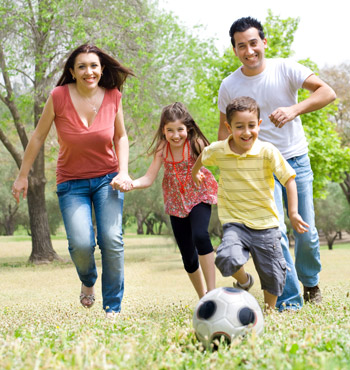 family playing soccer together