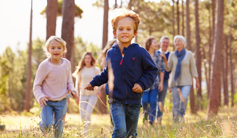 family taking a hike through a park