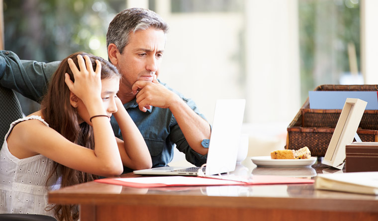 father helping daughter with homework