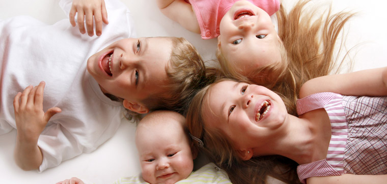 four young children laughing