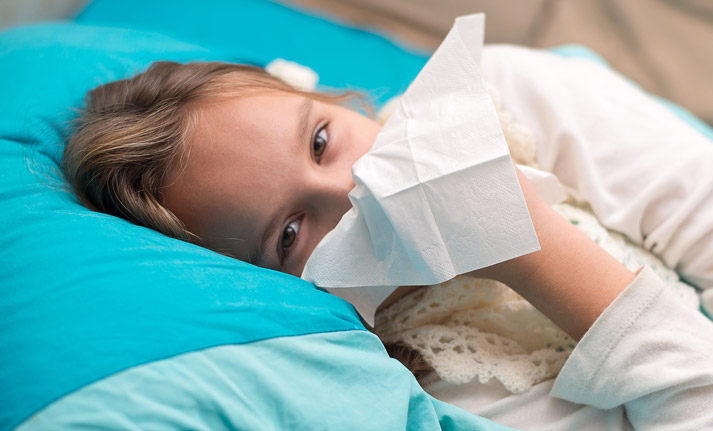 girl not feeling well lying in bed