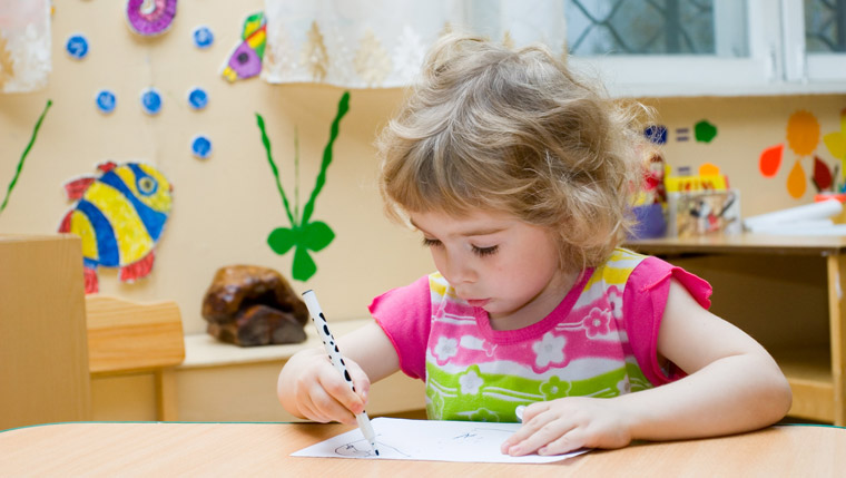 girl playing with marker