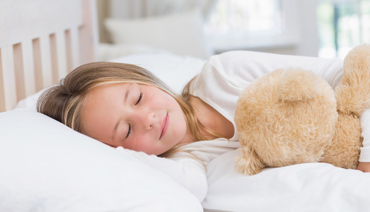 girl sleeping with stuffed animal