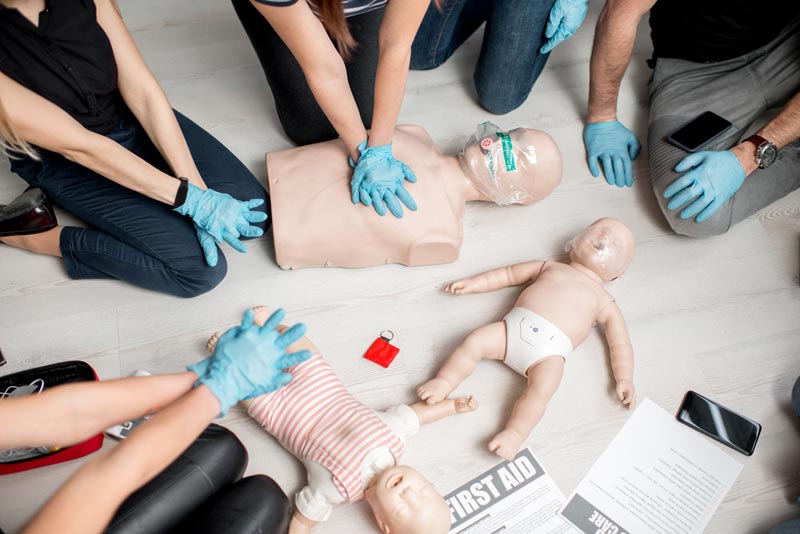 group CPR practice training with dummies