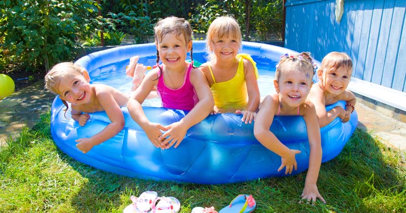 group of young children playing in a small pool