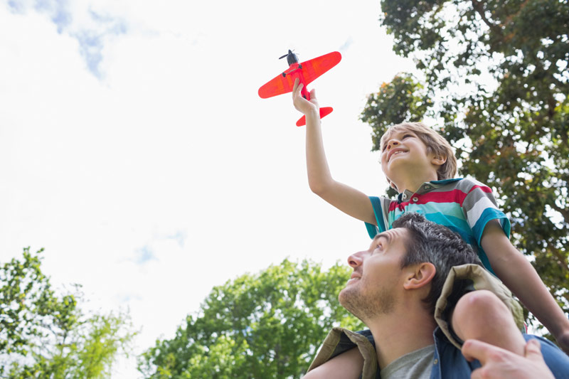 helicopter boy riding on dads shoulders