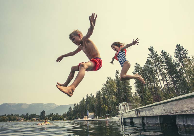 kids jumping off dock into lake