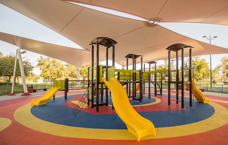 children's outdoor playground area built with sun shade panels overhead