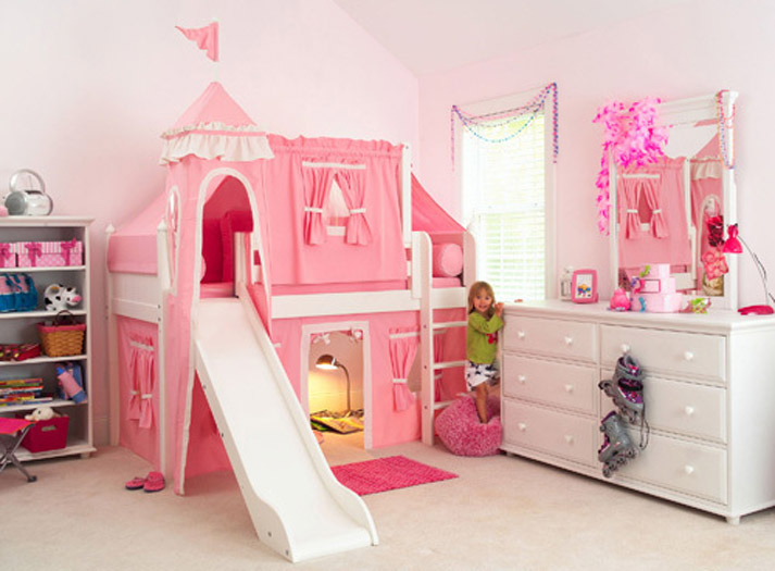 Low loft bed with pink curtains and slide