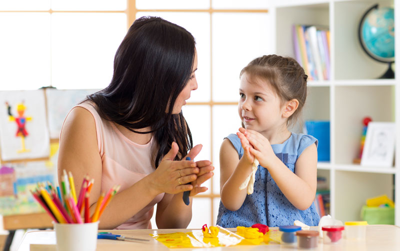 mom and little girl playing with modeling dough