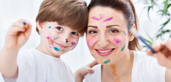 mom and son having fun with paints