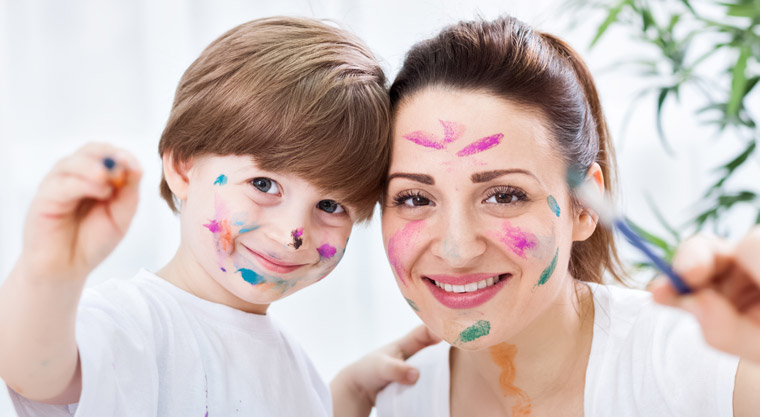 mom and son with paint splattered on clothing