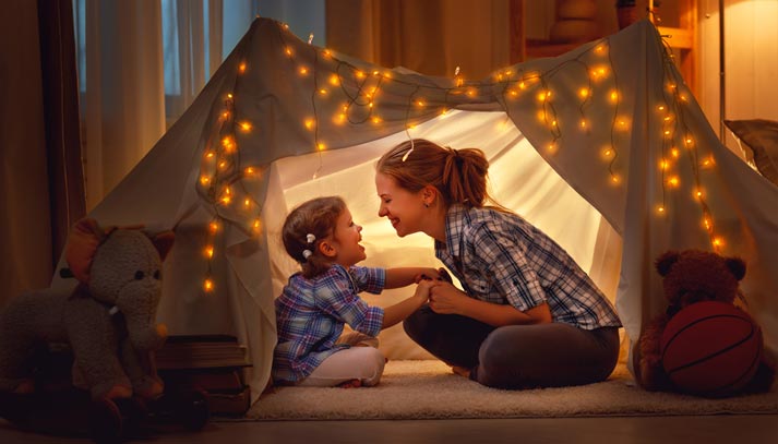 mom and daughter camping out in living room