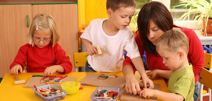 mom helping small kids with projects