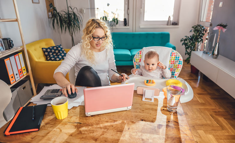 mom working from home and tending to the baby