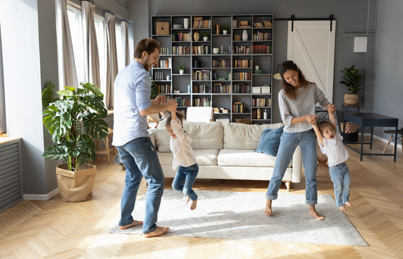 mother and dad playing with two young children