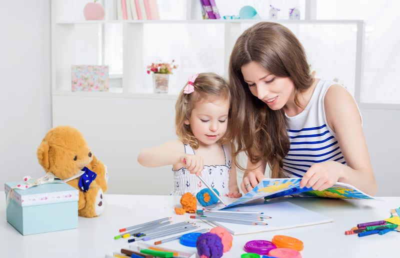 mother and daughter working through a coloring book