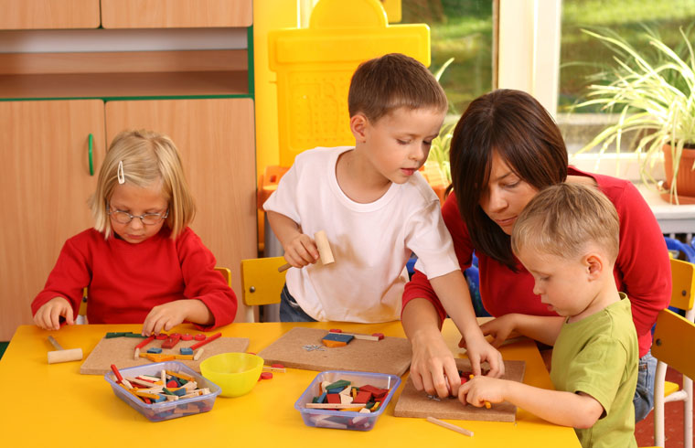 mother helping children build various items