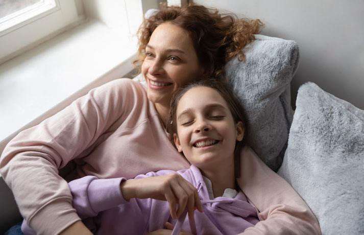mother smiling with teen daughter