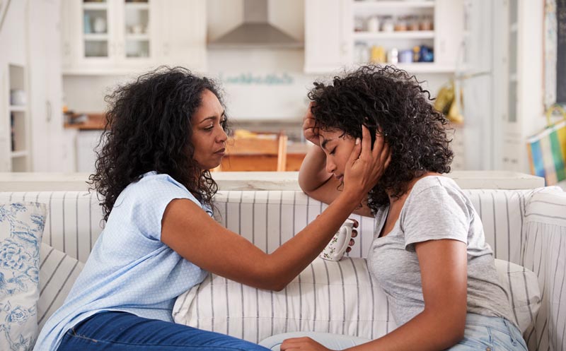 mother talking with teenage daughter who has had a rough day