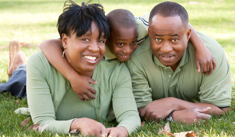 parents on grass with young child