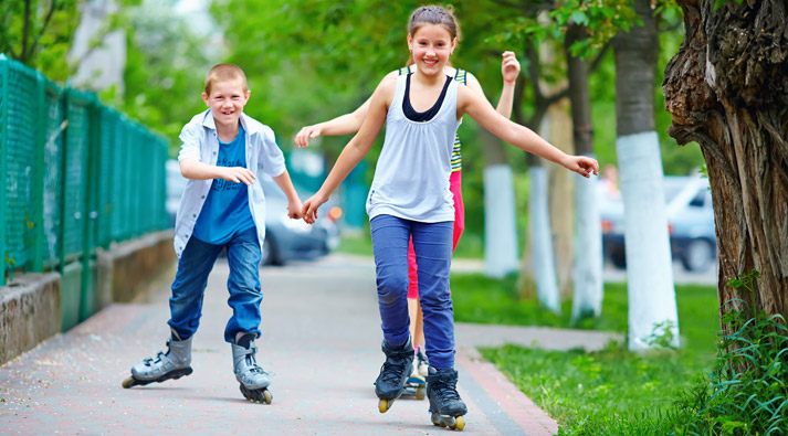rollerblading kids on the sidewalk