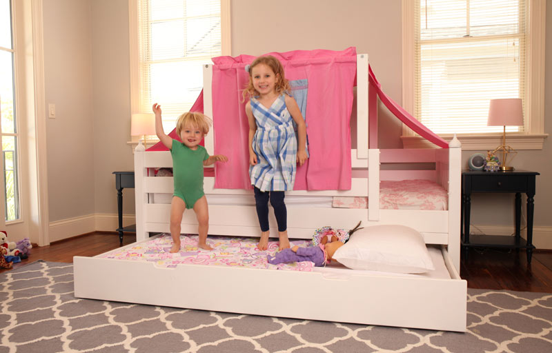 sister with little brother jumping on Maxtrix toddler trundle bed