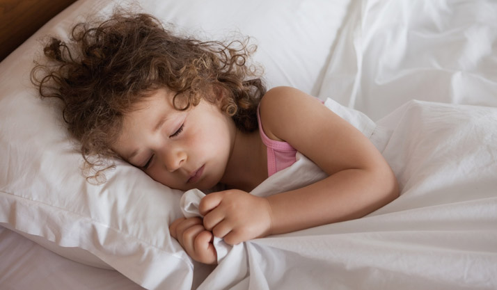 sleeping girl holding blanket