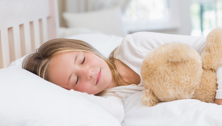 sleeping girl with teddy bear