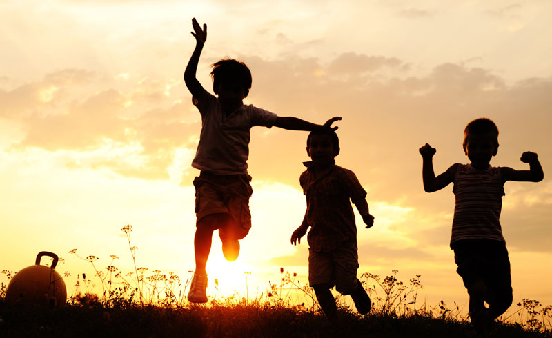 three kids having fun playing outside