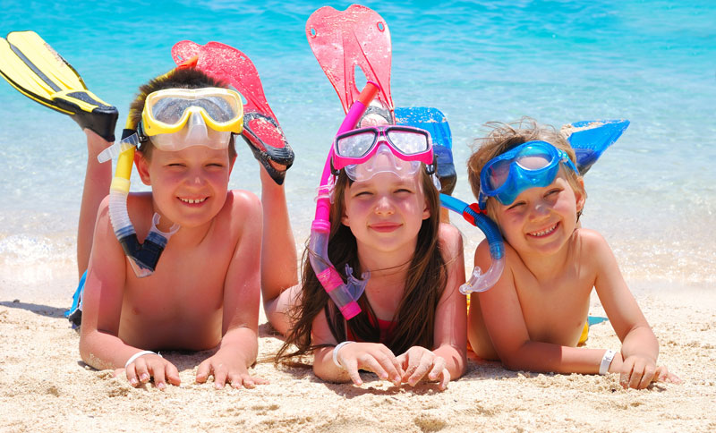 three siblings having fun at the beach