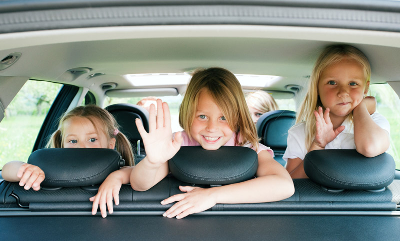 three young sisters in a car heading off for vacation