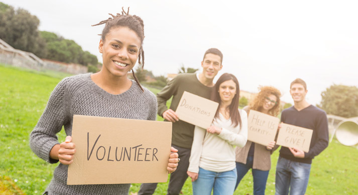 volunteers holding signs