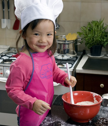 young baker girl making dough