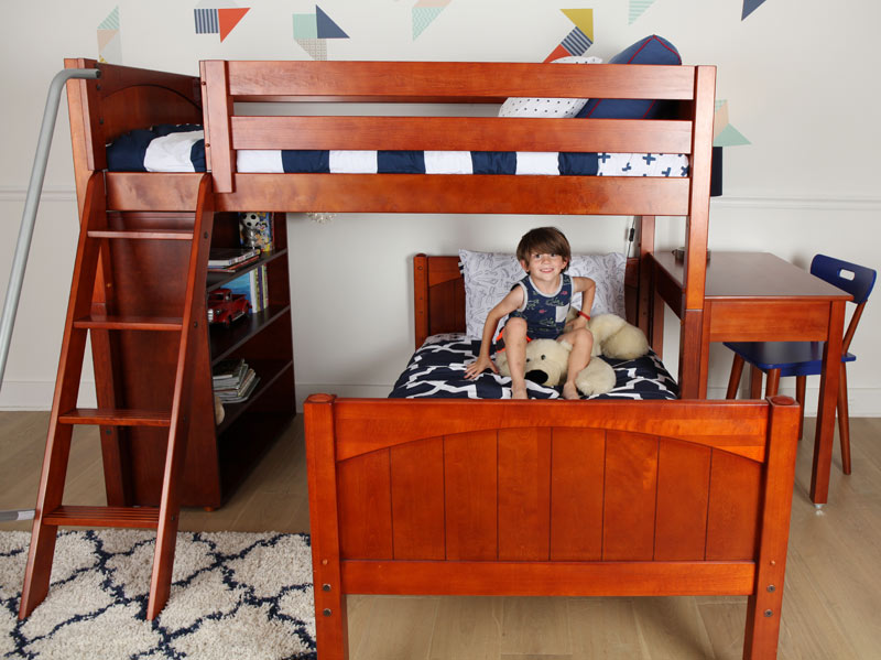young boy enjoying his Maxtrix bedroom setup with loft bed and extra bed below