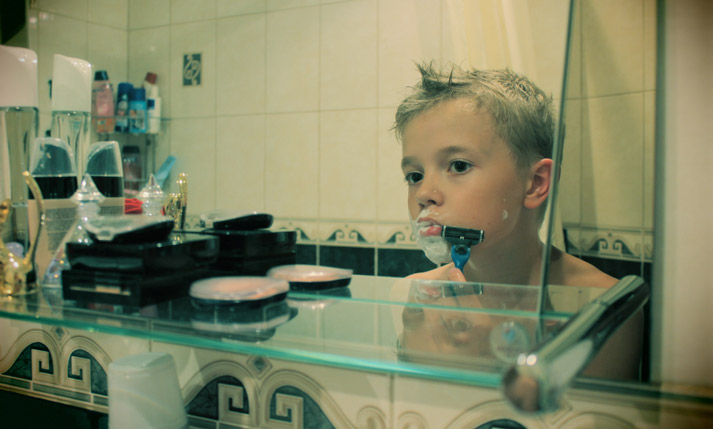 young boy pretending to shave