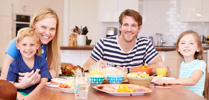 young family about to eat dinner meal